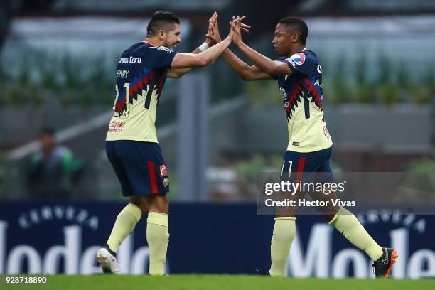 Andres Ibarguen of America celebrates with teammate Henry Martin after scoring the fourth goal of his team during the match between America and Tauro...