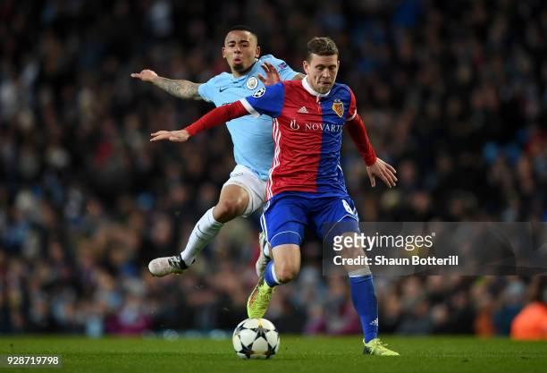 Fabian Frei of FC Basel holds off pressure from Gabriel Jesus of Manchester City during the UEFA Champions League Round of 16 Second Leg match...