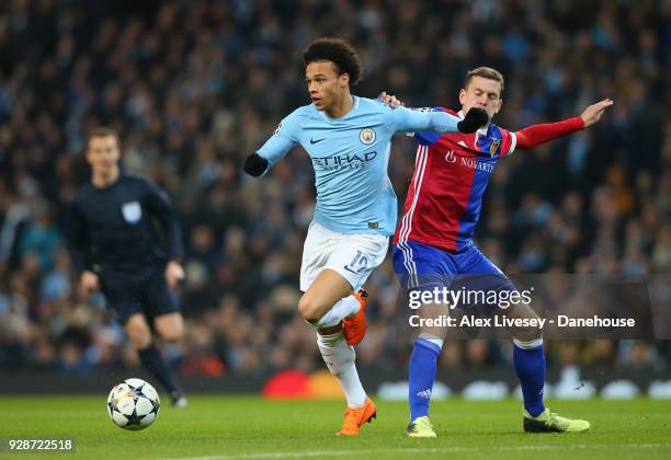 Leroy Sane of Manchester City beats Fabian Frei of FC Basel during the UEFA Champions League Round of 16 Second Leg match between Manchester City and...