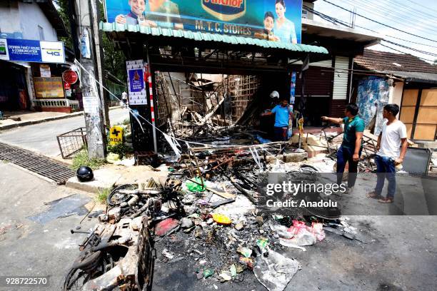 Sri Lankan Muslims, inspect their fire gutted remains of a business establishment at the Digana town in Kandy 117 kms from Colombo, Sri Lanka 7 March...