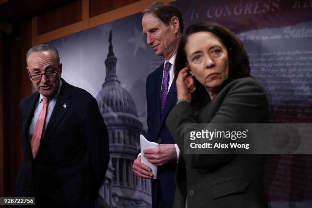 Senate Minority Leader Chuck Schumer speaks as Sens. Ron Wyden and Maria Cantwell listen during a news conference at the Capitol March 7, 2018 in...
