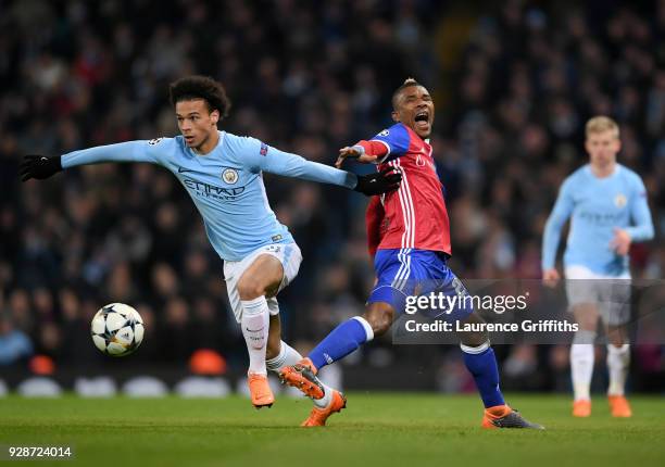 Leroy Sane of Manchester City holds off pressure from Geoffroy Serey Die of FC Basel during the UEFA Champions League Round of 16 Second Leg match...
