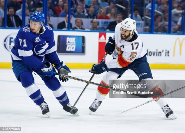 Anthony Cirelli of the Tampa Bay Lightning skates against Derek MacKenzie of the Florida Panthers during the second period at Amalie Arena on March...