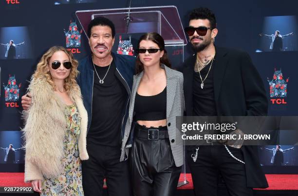 Lionel Ritchie with his children Nicole , Sofia and Miles pose at his Hand and Footprints ceremony at the TCL Theater on March 7,2018 in Hollywood,...