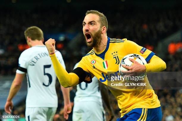 Juventus' Argentinian striker Gonzalo Higuain celebrates scoring their first goal to make the score 1-1 during the UEFA Champions League round of...