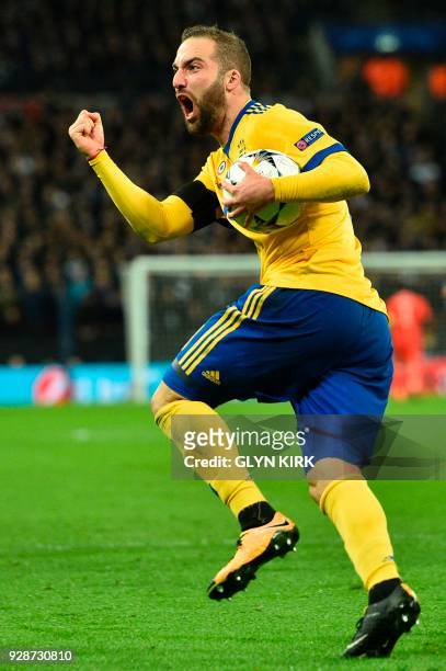 Juventus' Argentinian striker Gonzalo Higuain celebrates after scoring their first goal during the UEFA Champions League round of sixteen second leg...