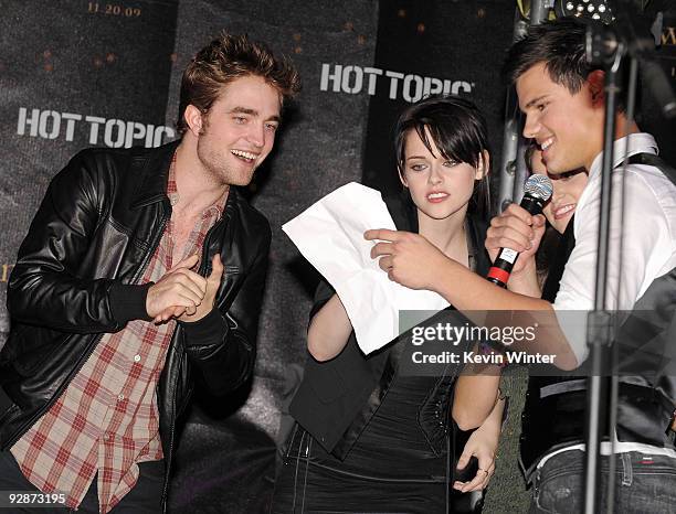 Actors Robert Pattinson, Kristen Stewart and Taylor Lautner appear onstage at Summit's "The Twilight Saga: New Moon" Cast Tour at Hollywood and...