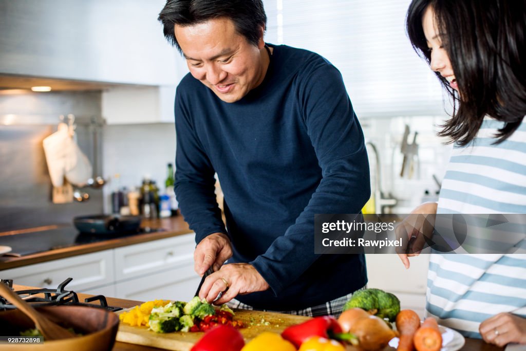Asian couple cooking in the kitchen