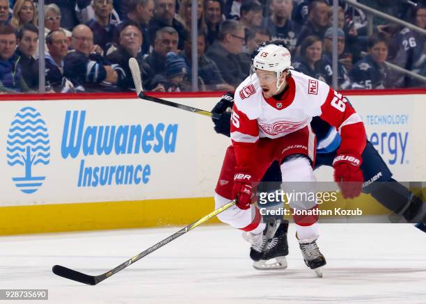 Danny DeKeyser of the Detroit Red Wings follows the play down the ice during first period action against the Winnipeg Jets at the Bell MTS Place on...