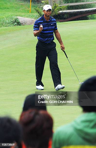 Tiger Woods of the US acknowledges the cheering crowd during the third round of the HSBC Champions golf tournament at the Sheshan International Golf...