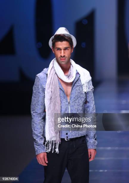 Model walks the runway in the 'ROMON' L&XF Men's Wear Fashion Show S/S 2010 during China Fashion Week on November 6, 2009 in Beijing, China.