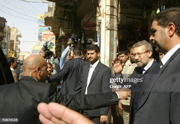 Iran's parliament speaker Ali Larijani waves to the press after meeting with Iraq's top Shiite cleric Grand Ayatollah Ali Husseini al-Sistani in the...