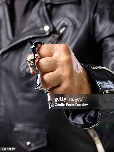 close up of fist with knuckle duster. - knuckle duster imagens e fotografias de stock