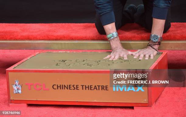Lionel Ritchie puts his hands in the block of cement at his Hand and Footprints ceremony at the TCL Theater on March 7,2018 in Hollywood, California....