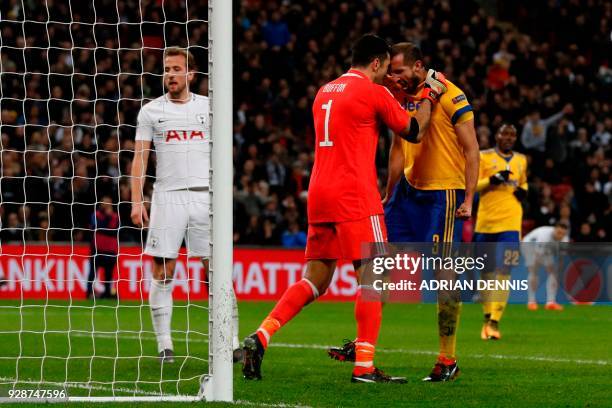 Juventus' Italian defender Giorgio Chiellini reacts with Juventus' Italian goalkeeper Gianluigi Buffon after making an interception during the UEFA...