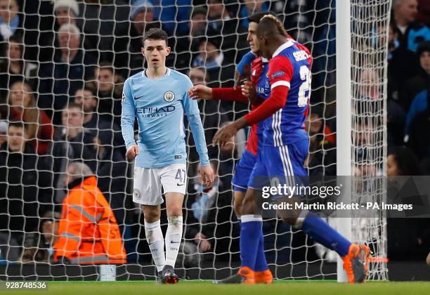 Manchester City's Phil Foden appears dejected as FC Basel players celebrate their second goal during the UEFA Champions League round of 16, second...