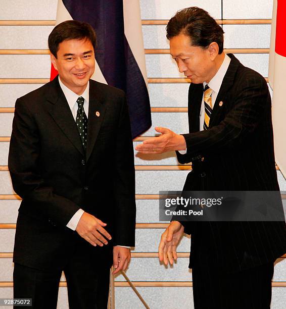 Thai Prime Minister Abhisit Vejjajiva, left, is welcomed by his Japanese counterpart Yukio Hatoyama prior to their meeting at the latter's official...