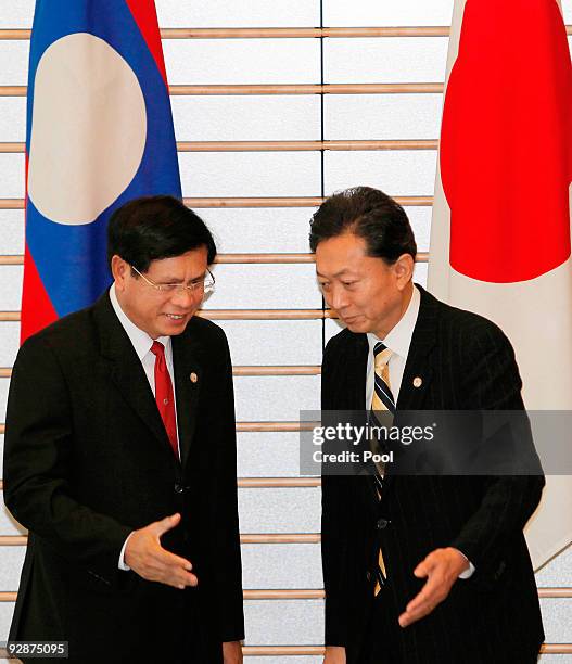 Laotian Prime Minister Bouasone Bouphavanh, left, is welcomed by Japanese Prime Minister Yukio Hatoyama at the Japanese PM's official residence prior...