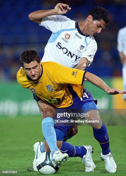 Joel Porter of the Gold Coast is challenged by Simon Colosimo during the round 14 A-League match between Gold Coast United and Sydney FC at Skilled...