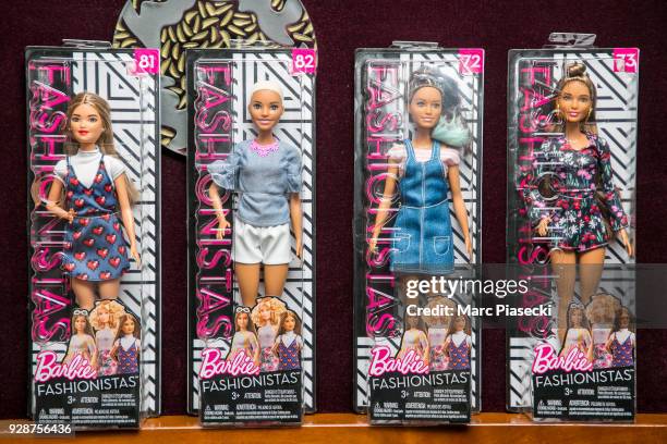 Close-up at Barbie dolls ahead Mattel honoring global role models on International Women's Day at Helene Darroze Restaurant on March 7, 2018 in...