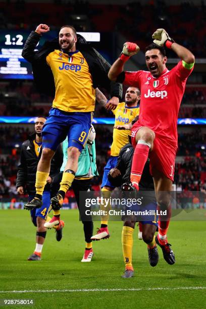 Gianluigi Buffon and Gonzalo Higuain both of Juventus celebrate victory after the UEFA Champions League Round of 16 Second Leg match between...