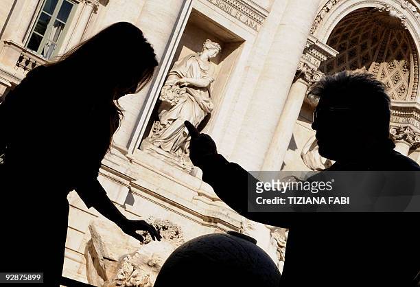 Spanish actress Penelope Cruz and Spanish film director Pedro Almodovar pose at the Fontana Di Trevi during the photocall of "Los Abrazos Roto" on...