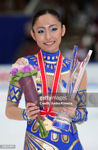 Winner Miki Ando of Japan poses for photographs after competing in the Ladies Free Skating on the day one of ISU Grand Prix of Figure Skating NHK...