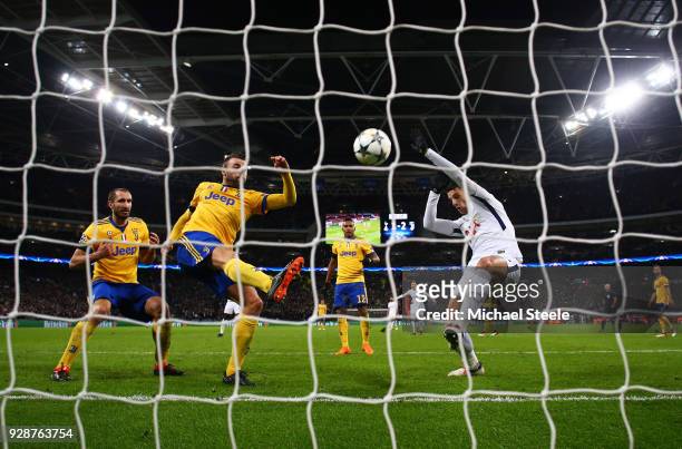 Andrea Barzagli of Juventus clears the ball from the goal line under pressure from Erik Lamela of Tottenham Hotspur during the UEFA Champions League...