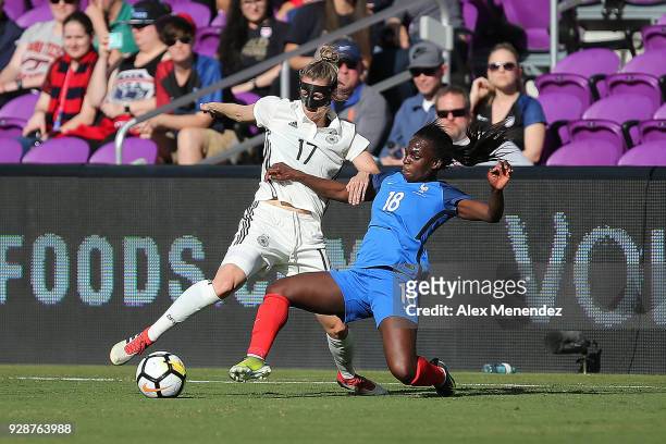Verena Fai§t of Germany and Viviane Asseyi of France fight for the ball during the SheBelieves Cup soccer match at Orlando City Stadium on March 7,...
