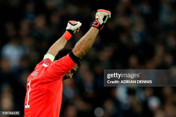 Juventus' Italian goalkeeper Gianluigi Buffon celebrates their victory at the final whistle in the UEFA Champions League round of sixteen second leg...