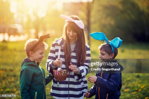 kids playing easter egg hunt - easter poland stock pictures, royalty-free photos & images