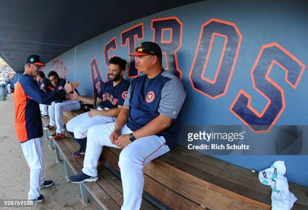 Former Houston Astros second baseman and Hall of Famer Craig Biggio shakes hands with Jose Altuve as Omar Lopez listens in during a spring training...