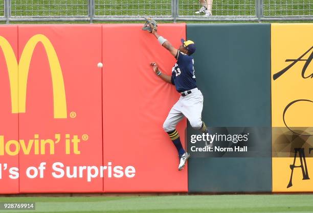 Keon Broxton of the Milwaukee Brewers crashes into the outfield wall attempting to make a leaping catch on a hit by Tyler Collins of the Kansas City...