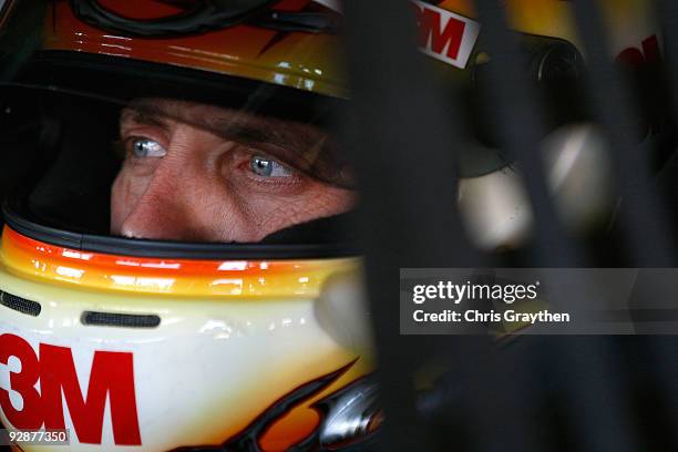 Greg Biffle, driver of the 3M Scotch Super 33 Tape Ford, sits in his car during practice for the NASCAR Sprint Cup Series Dickies 500 at Texas Motor...