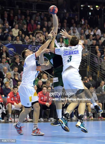 Christian O«Sullivan of SC Magdeburg, Marko Kopljar of Fuechse Berlin and Piotr Chrapkowski of SC Magdeburg during the DHB Cup quarterfinal game...