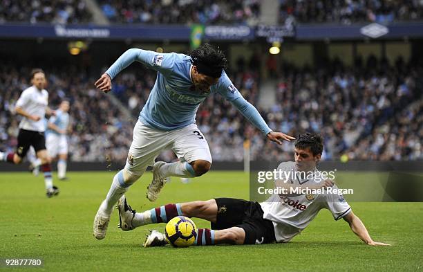 Carlos Tevez of Manchester City is challenged by Stephen Jordan of Burnley during the Barclays Premier League match between Manchester City and...