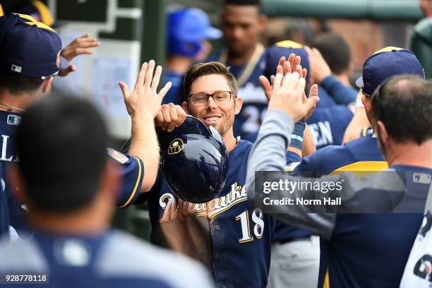 Eric Sogard of the Milwaukee Brewers celebrates with teammates in the dugout after scoring on a double by Hernan Perez during the fifth inning of a...