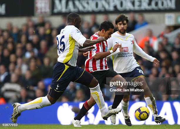 Kieran Richardson of Sunderland is closed down by Ledley King and Vedran Corluka of Tottenham Hotspur during the Barclays Premier League match...