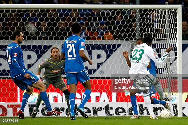 Grafite of Wolfsburg scores his team's second goal against Marvin Compper, Luiz Gustavo, goalkeeper Timo Hildebrand and Josip Simunic of Hoffenheim...