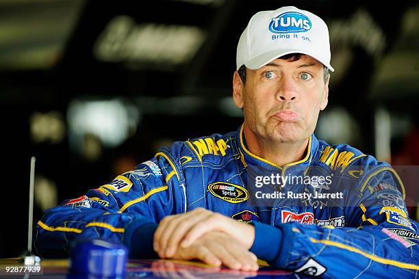 Michael Waltrip, driver of the NAPA Toyota, stands in the garage prior to practice for the NASCAR Sprint Cup Series Dickies 500 at Texas Motor...