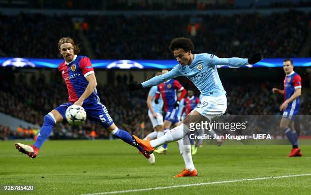 Leroy Sane of Manchester City shoots past Michael Lang of Basel during the UEFA Champions League Round of 16 Second Leg match between Manchester City...
