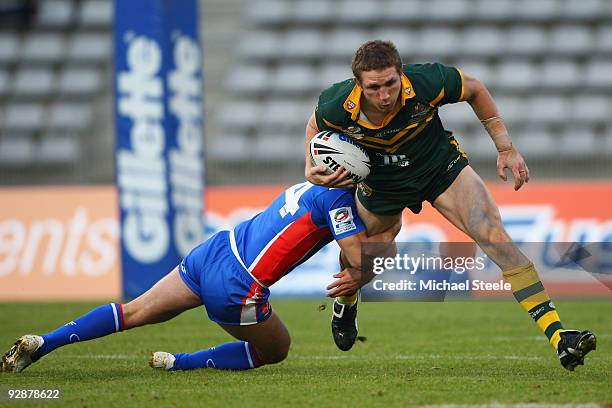 Ryan Hoffman of Australia is held up by Sebastien Raguin during the Four Nations match between France and Australia at Stade Charlety on November 7,...