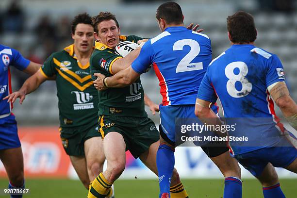 Kurt Gidley of Australia is held up by Dimitri Pelo of France during the Four Nations match between France and Australia at Stade Charlety on...