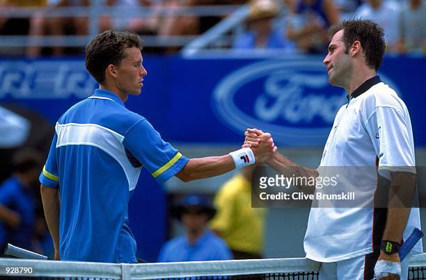 Greg Rusedski of the UK, shakes hands at the completion of the match, with Lars Burgsmuller of Germany, during the sixth day of the Australian Open...