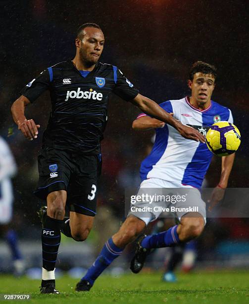 Younes Kaboul of Portsmouth in action with Franco Di Santo of Blackburn Rovers during the Barclays Premier League match between Blackburn Rovers and...