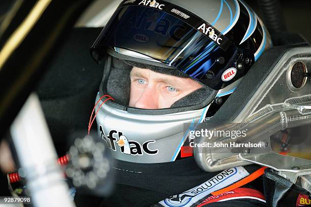 Carl Edwards, driver of the Aflac Ford, sits in his car during practice for the NASCAR Sprint Cup Series Dickies 500 at Texas Motor Speedway on...