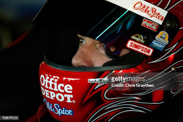 Tony Stewart, driver of the Office Depot/Old Spice Chevrolet, sits in his car during practice for the NASCAR Sprint Cup Series Dickies 500 at Texas...