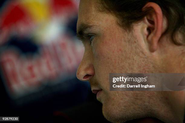 Scott Speed, driver of the Red Bull Toyota, stands in the garage during practice for the NASCAR Sprint Cup Series Dickies 500 at Texas Motor Speedway...