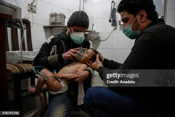 An affected child receives treatment after an alleged gas attack on Sakba and Hammuriye areas, in Eastern Ghouta, Syria on March 7, 2018. According...