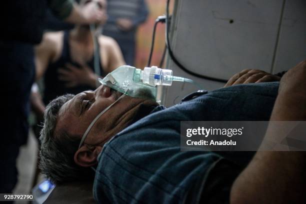 An affected man receives treatment after an alleged gas attack on Sakba and Hammuriye areas, in Eastern Ghouta, Syria on March 7, 2018. According to...